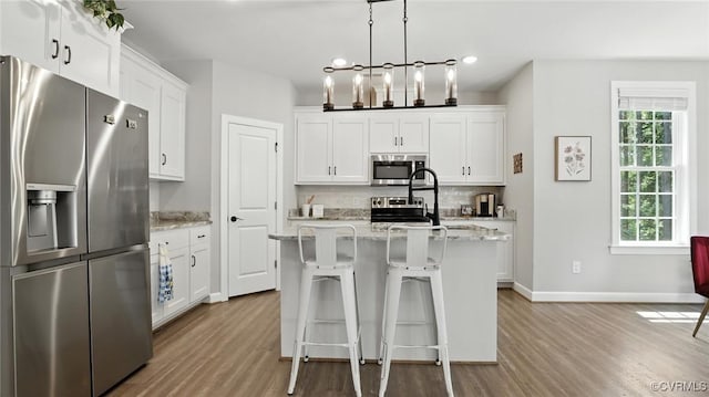 5080 Brandon Pines Way, Providence Forge, VA 23140 - kitchen with appliances with stainless steel finishes, wood finished floors, healthy amount of natural light, tasteful backsplash, and recessed lighting