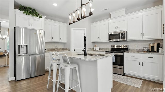 5080 Brandon Pines Way, Providence Forge, VA 23140 - kitchen with appliances with stainless steel finishes, wood finished floors, tasteful backsplash, and recessed lighting