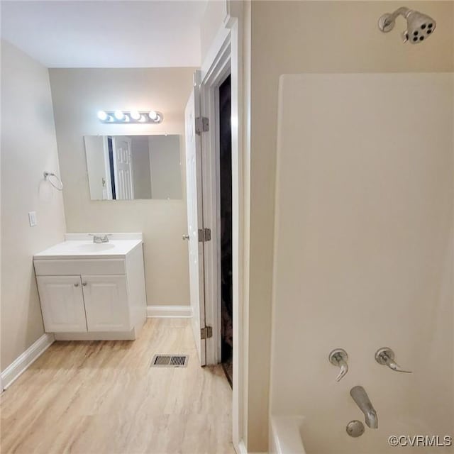9210 Park St, Amelia Courthouse, VA 23002 - full bath featuring vanity, washtub / shower combination, and wood finished floors