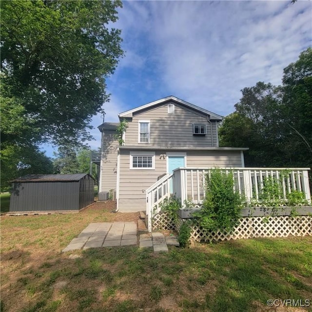 9210 Park St, Amelia Courthouse, VA 23002 - back of property with a storage unit, a deck, and a yard
