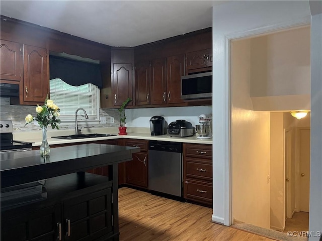 4009 Robert E Lee Dr, North Prince George, VA 23860 - kitchen featuring stainless steel appliances, range hood, light wood-style flooring, and decorative backsplash