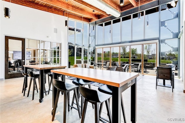 3900 Maze Runner Dr Unit 205, Chesterfield, VA 23112 - dining space with finished concrete floors, a towering ceiling, and a wooden ceiling with exposed beams