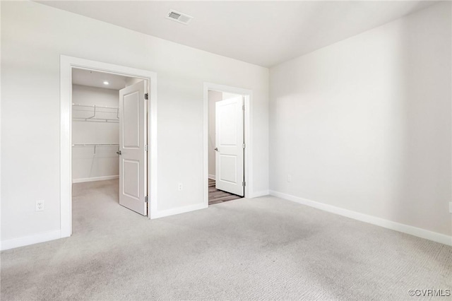 3900 Maze Runner Dr Unit 205, Chesterfield, VA 23112 - unfurnished bedroom with carpet floors, a walk in closet, and a closet