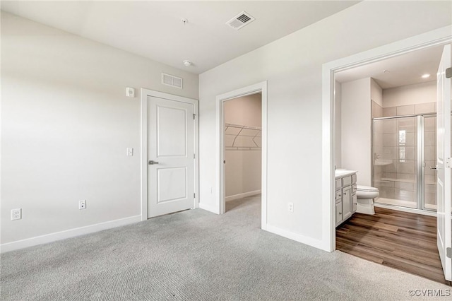 3900 Maze Runner Dr Unit 205, Chesterfield, VA 23112 - unfurnished bedroom featuring a walk in closet, carpet flooring, a closet, and ensuite bathroom
