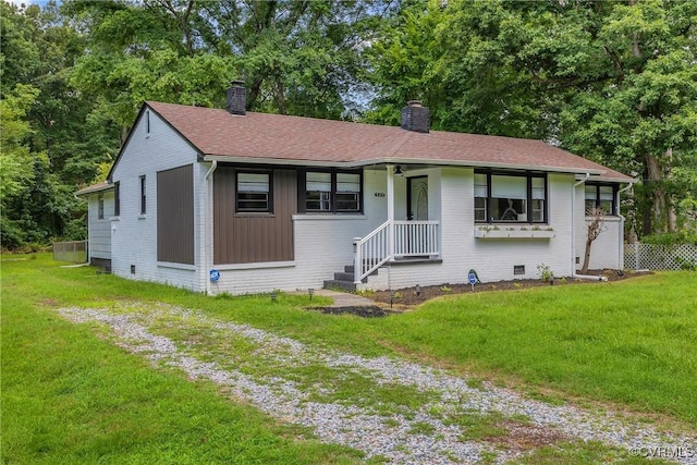 520 Heth Rd, Petersburg, VA 23805 - view of front of house featuring a chimney, a front yard, brick siding, and a shingled roof