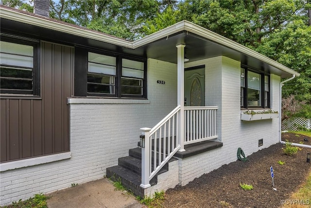 520 Heth Rd, Petersburg, VA 23805 - doorway to property featuring brick siding, board and batten siding, and crawl space