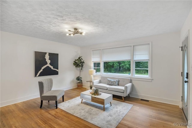 520 Heth Rd, Petersburg, VA 23805 - living area featuring a chandelier, light wood-type flooring, and a textured ceiling