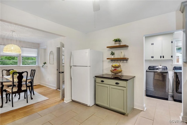 520 Heth Rd, Petersburg, VA 23805 - kitchen featuring freestanding refrigerator, separate washer and dryer, dark countertops, and healthy amount of natural light