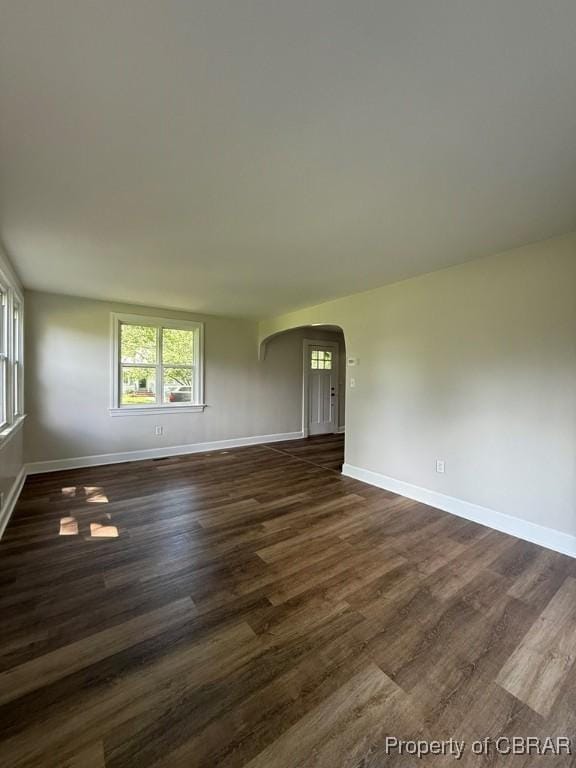 36 Roseneath Ave, Kilmarnock, VA 22482 - empty room with arched walkways and dark wood-style flooring