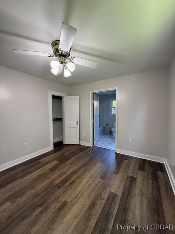 36 Roseneath Ave, Kilmarnock, VA 22482 - unfurnished bedroom featuring dark wood-style flooring, connected bathroom, and ceiling fan