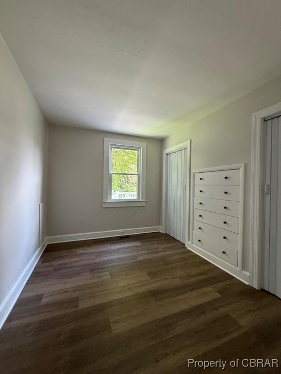 36 Roseneath Ave, Kilmarnock, VA 22482 - unfurnished bedroom featuring two closets and dark wood-style flooring