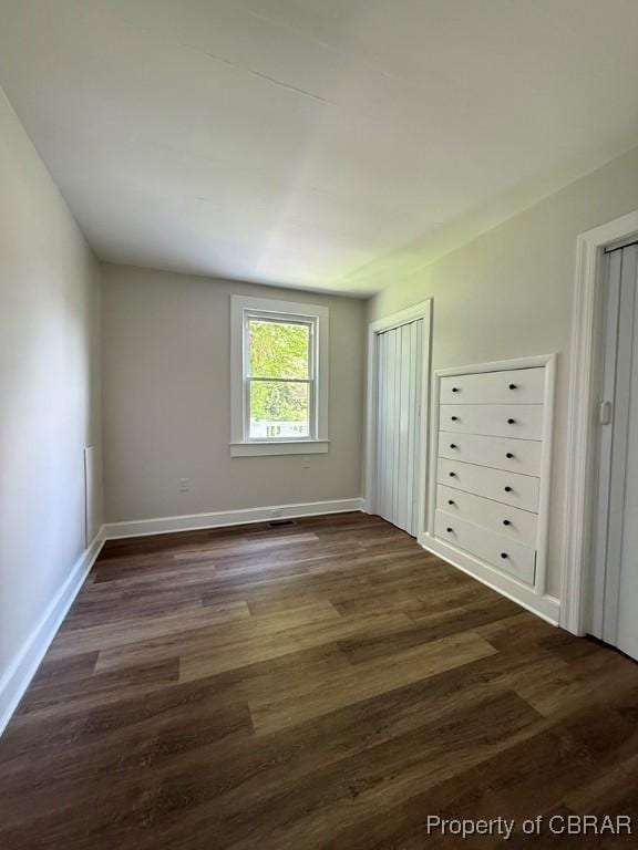 36 Roseneath Ave, Kilmarnock, VA 22482 - unfurnished bedroom with dark wood-style floors and two closets