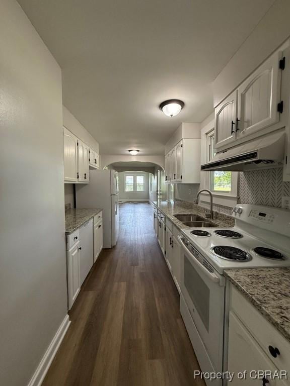 36 Roseneath Ave, Kilmarnock, VA 22482 - kitchen featuring white appliances, under cabinet range hood, arched walkways, and dark wood-style floors