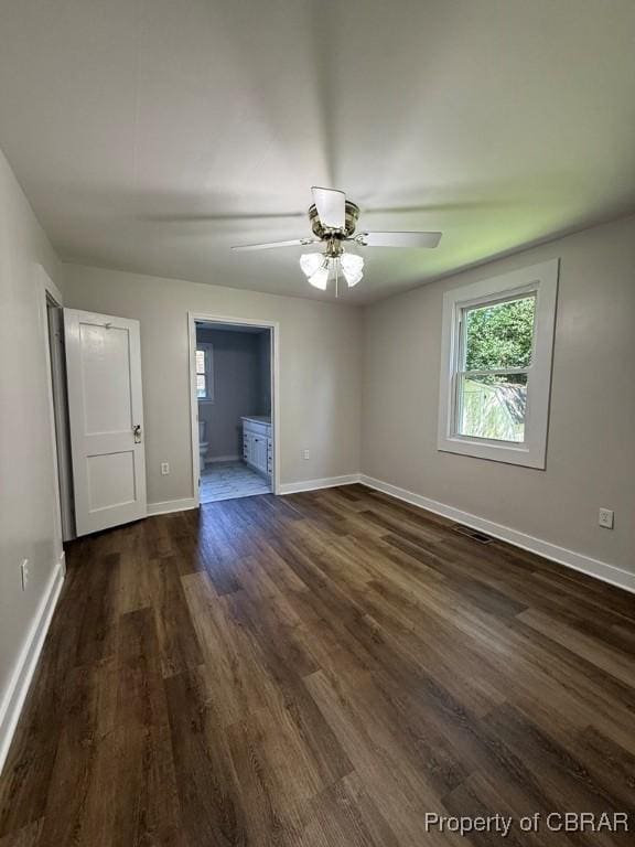36 Roseneath Ave, Kilmarnock, VA 22482 - empty room featuring dark wood-style flooring, plenty of natural light, and a ceiling fan