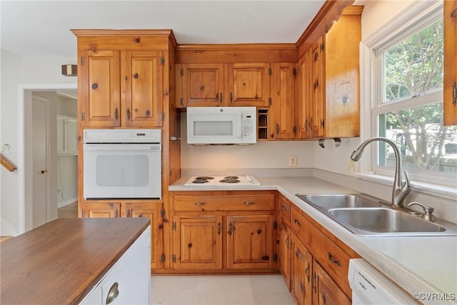 2411 Colwyn Rd, Henrico, VA 23229 - kitchen with white appliances, brown cabinetry, and light countertops