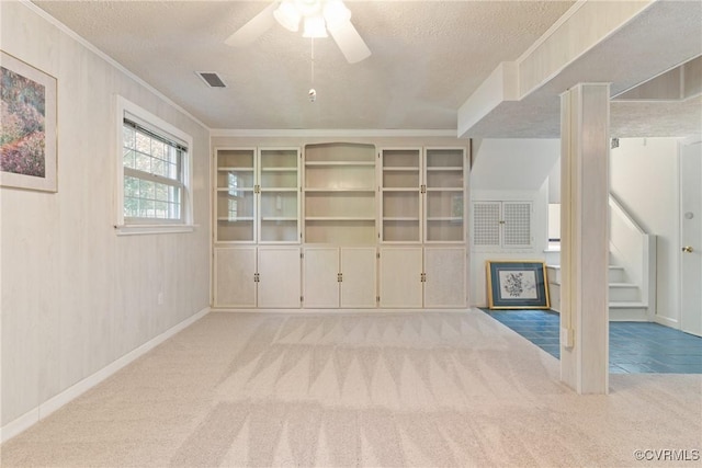 2411 Colwyn Rd, Henrico, VA 23229 - unfurnished living room featuring a textured ceiling, carpet flooring, a ceiling fan, stairs, and crown molding