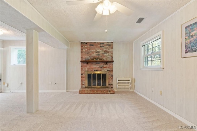 2411 Colwyn Rd, Henrico, VA 23229 - unfurnished living room featuring a textured ceiling, healthy amount of natural light, ornamental molding, carpet flooring, and a fireplace