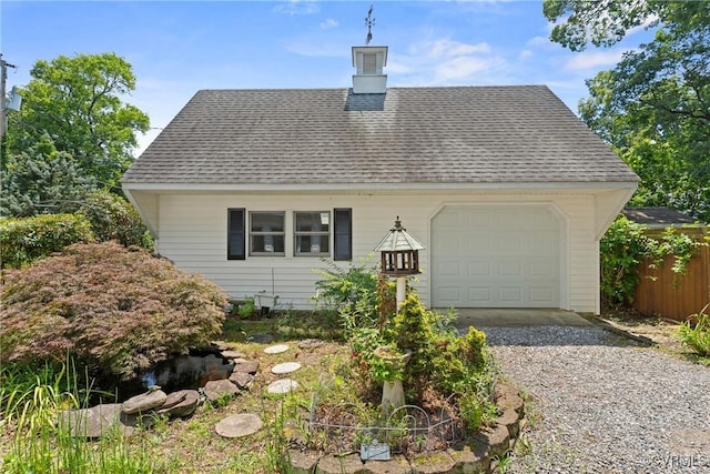 2411 Colwyn Rd, Henrico, VA 23229 - view of front of home with gravel driveway, a shingled roof, an attached garage, and a chimney