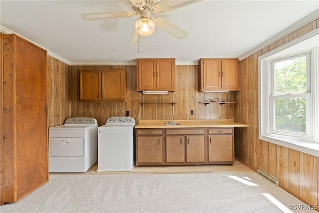 2411 Colwyn Rd, Henrico, VA 23229 - laundry area with cabinet space, washer and dryer, wooden walls, a ceiling fan, and light colored carpet