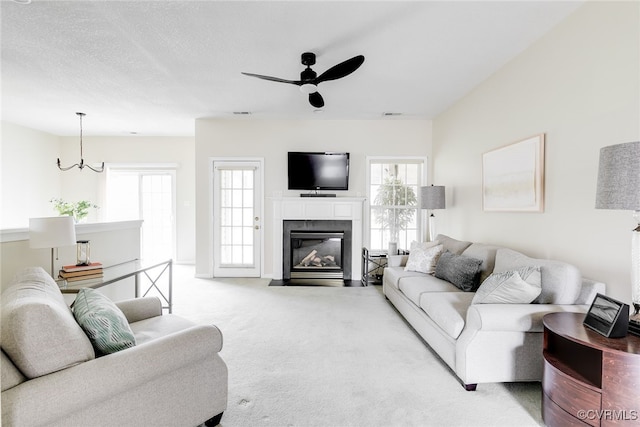 4017 Bayapple Dr, Henrico, VA 23294 - living room featuring a ceiling fan, carpet floors, a tile fireplace, and a chandelier