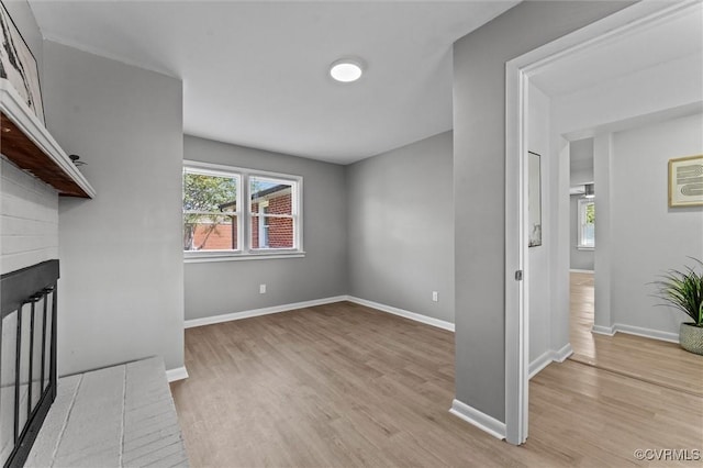 2000 Cleary Rd, Richmond, VA 23223 - unfurnished living room featuring light wood finished floors and a brick fireplace