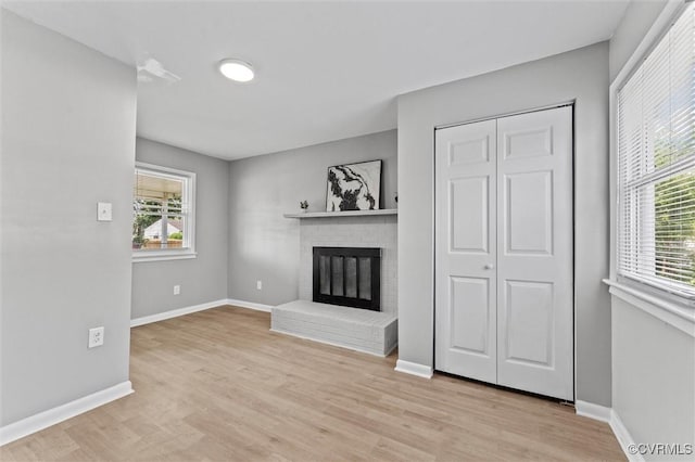 2000 Cleary Rd, Richmond, VA 23223 - unfurnished living room featuring light wood finished floors and a fireplace