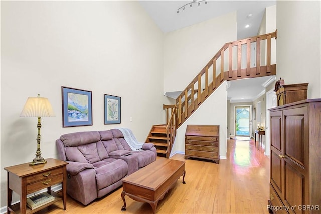 10 Heatherfield Ct Unit 10, Kilmarnock, VA 22482 - living room with stairs, a towering ceiling, and light wood-style flooring