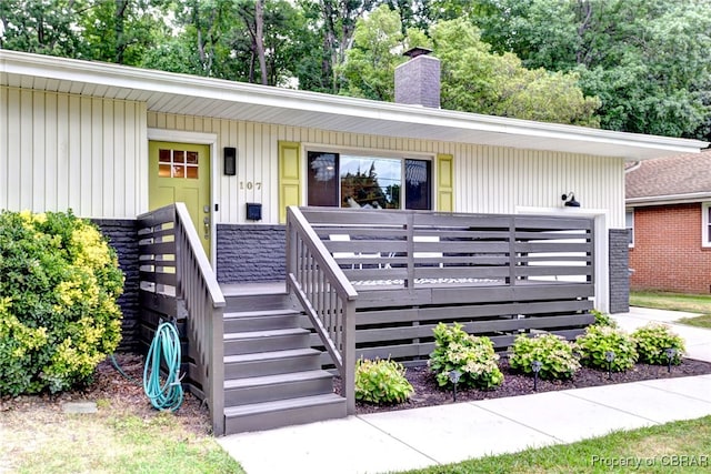 107 Ward, Hampton, VA 23669 - view of front facade with a chimney, covered porch, and view of scattered trees