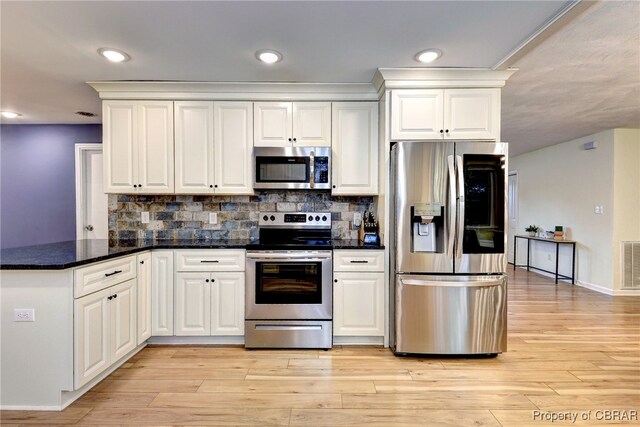 107 Ward, Hampton, VA 23669 - kitchen featuring stainless steel appliances, a peninsula, white cabinets, decorative backsplash, and light wood finished floors