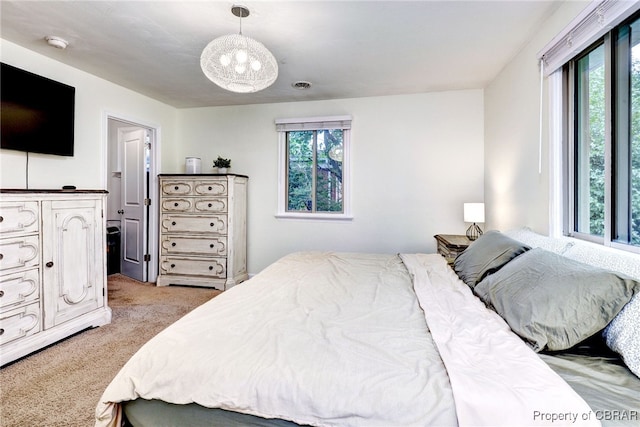 107 Ward, Hampton, VA 23669 - bedroom featuring multiple windows, light colored carpet, and a chandelier