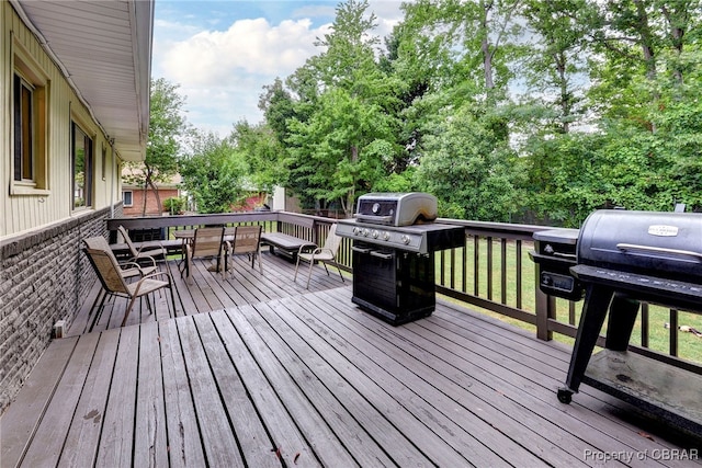 107 Ward, Hampton, VA 23669 - wooden deck with a grill, outdoor dining area, and view of scattered trees