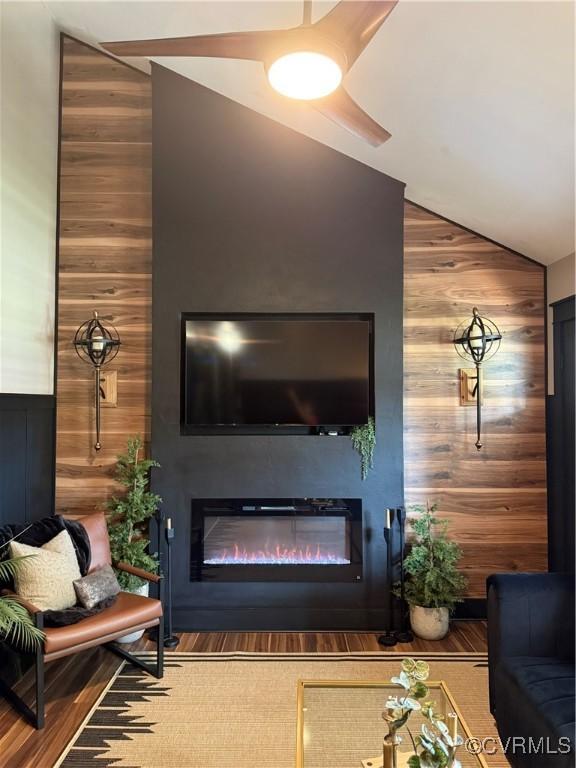 5754 Fox Maple Ter, Chesterfield, VA 23803 - living area with wooden walls, a glass covered fireplace, high vaulted ceiling, and wood finished floors
