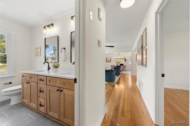 2207 Craven Ln, Henrico, VA 23228 - full bathroom featuring double vanity, plenty of natural light, and wood finished floors