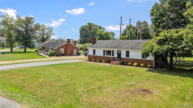 2207 Craven Ln, Henrico, VA 23228 - ranch-style home featuring gravel driveway, brick siding, and a front yard