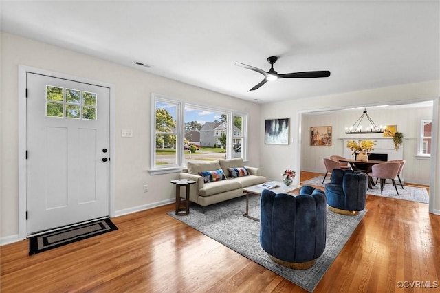 2207 Craven Ln, Henrico, VA 23228 - living room with wood finished floors, ceiling fan, and a chandelier