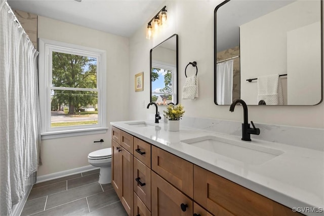 2207 Craven Ln, Henrico, VA 23228 - bathroom featuring plenty of natural light, double vanity, tile patterned floors, and curtained shower