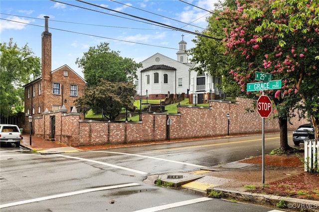 2502 E Grace St, Richmond, VA 23223 - view of asphalt street with street lights, curbs, traffic signs, and sidewalks