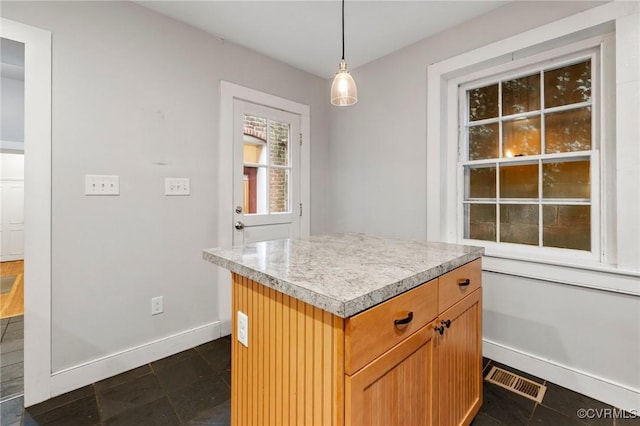 2502 E Grace St, Richmond, VA 23223 - kitchen featuring light countertops, hanging light fixtures, and a center island