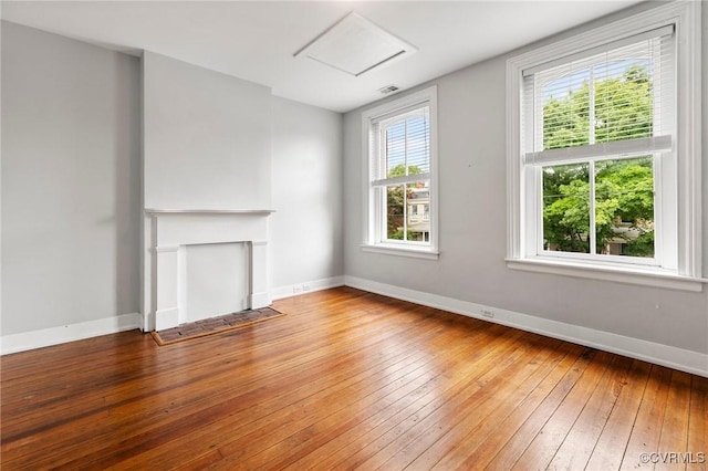 2502 E Grace St, Richmond, VA 23223 - unfurnished living room featuring hardwood / wood-style flooring and attic access