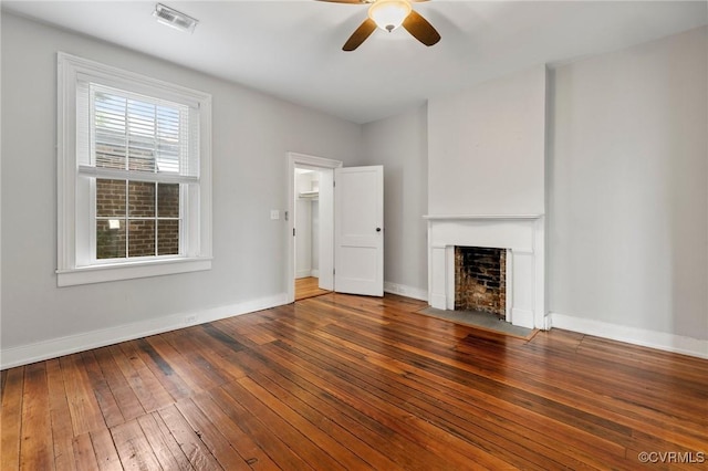 2502 E Grace St, Richmond, VA 23223 - unfurnished living room with wood-type flooring, ceiling fan, and a fireplace with flush hearth