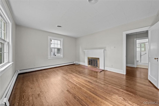 914 Kensington Ave, Colonial Heights, VA 23834 - unfurnished living room with baseboard heating, wood finished floors, and a glass covered fireplace