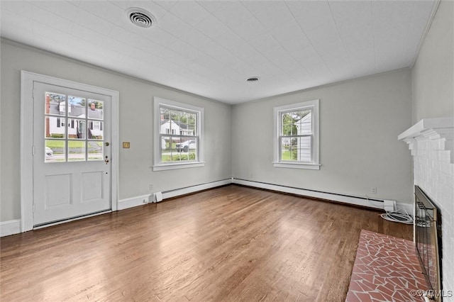 914 Kensington Ave, Colonial Heights, VA 23834 - unfurnished living room with a baseboard radiator, wood finished floors, and a fireplace