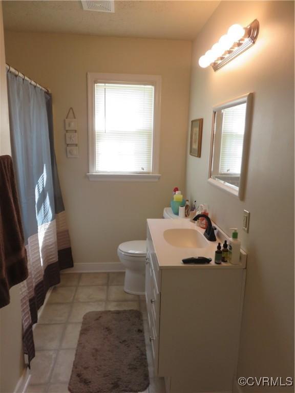 6329 Sledds Lake Rd, Mechanicsville, VA 23111 - bathroom with plenty of natural light, vanity, tile patterned flooring, and a shower with curtain