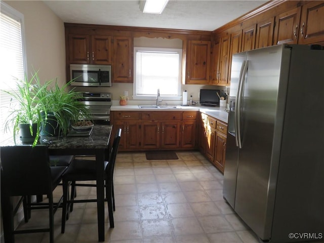 6329 Sledds Lake Rd, Mechanicsville, VA 23111 - kitchen featuring appliances with stainless steel finishes, brown cabinetry, and light countertops