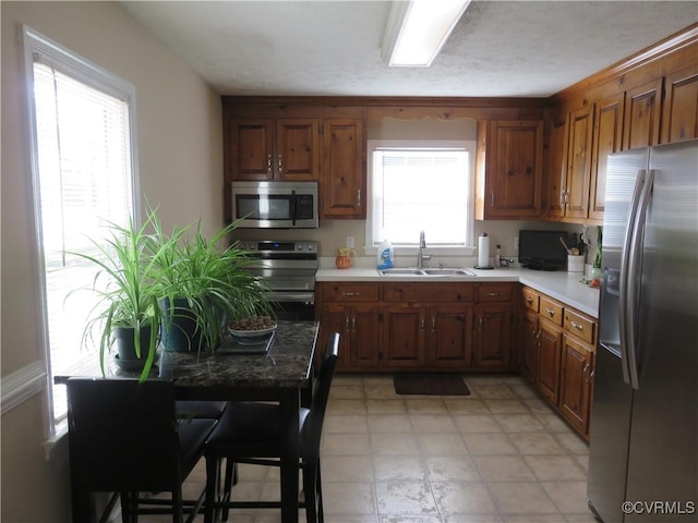 6329 Sledds Lake Rd, Mechanicsville, VA 23111 - kitchen with appliances with stainless steel finishes, light countertops, and brown cabinetry