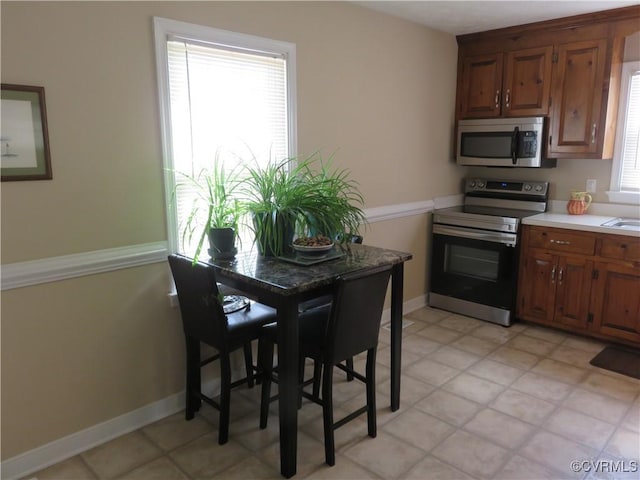 6329 Sledds Lake Rd, Mechanicsville, VA 23111 - kitchen featuring stainless steel appliances, light countertops, and brown cabinets