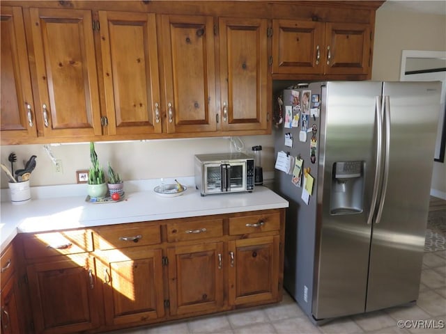 6329 Sledds Lake Rd, Mechanicsville, VA 23111 - kitchen featuring stainless steel fridge, brown cabinets, and light countertops