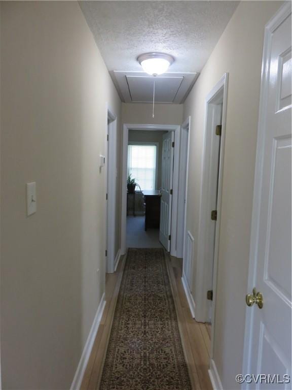 6329 Sledds Lake Rd, Mechanicsville, VA 23111 - corridor with attic access, a textured ceiling, and light wood-style flooring