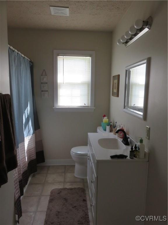 6329 Sledds Lake Rd, Mechanicsville, VA 23111 - bathroom with vanity, plenty of natural light, curtained shower, a textured ceiling, and tile patterned flooring