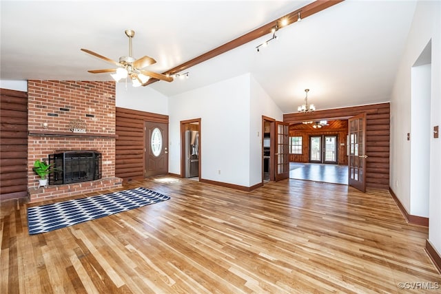 6631 Rural Point Rd, Mechanicsville, VA 23116 - unfurnished living room with ceiling fan, light wood-type flooring, a chandelier, a fireplace, and rustic walls